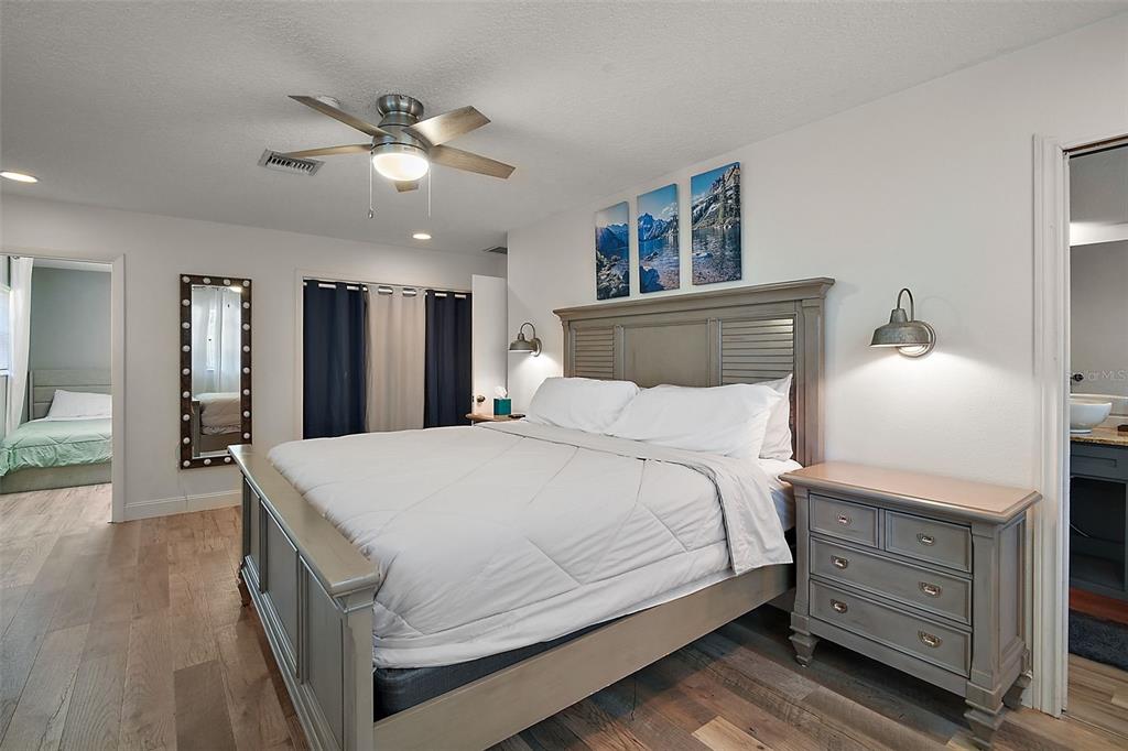 705 West Summit Court Mount Dora, FL 32757 - Photo 16 of 37 a spacious bedroom with a bed and a dresser