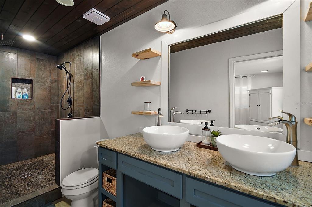 705 West Summit Court Mount Dora, FL 32757 - Photo 17 of 37 a bathroom with a granite countertop sink and a mirror