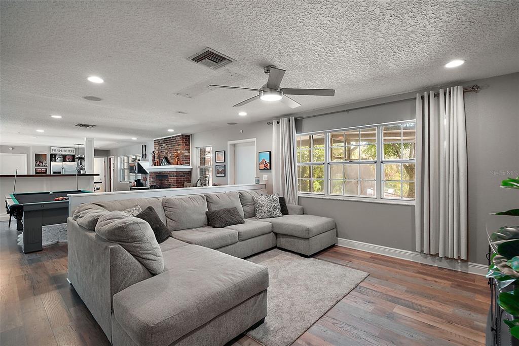 705 West Summit Court Mount Dora, FL 32757 - Photo 3 of 37 a living room with furniture and a large window