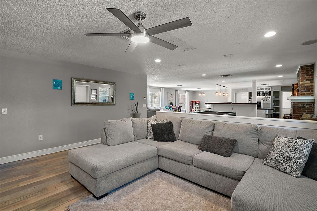 705 West Summit Court Mount Dora, FL 32757 - Photo 4 of 37 a living room with furniture and kitchen view