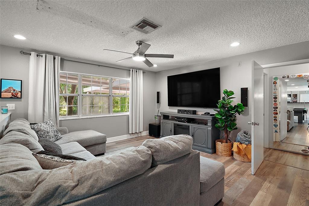 705 West Summit Court Mount Dora, FL 32757 - Photo 5 of 37 a living room with furniture and a flat screen tv