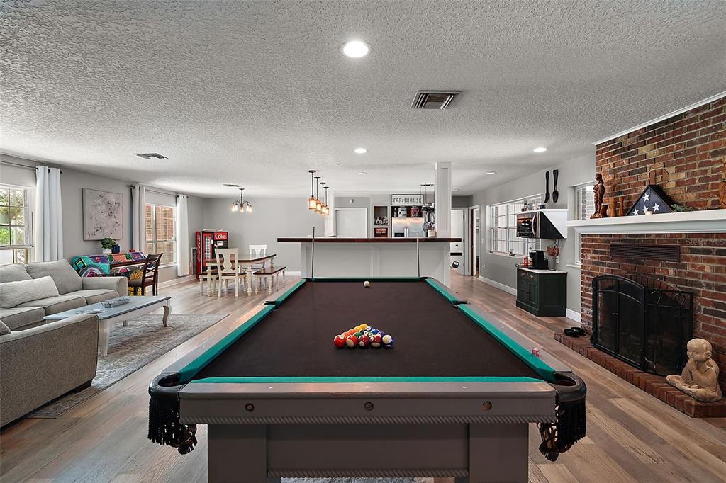 705 West Summit Court Mount Dora, FL 32757 - Photo 7 of 37 a room with pool table and a fireplace