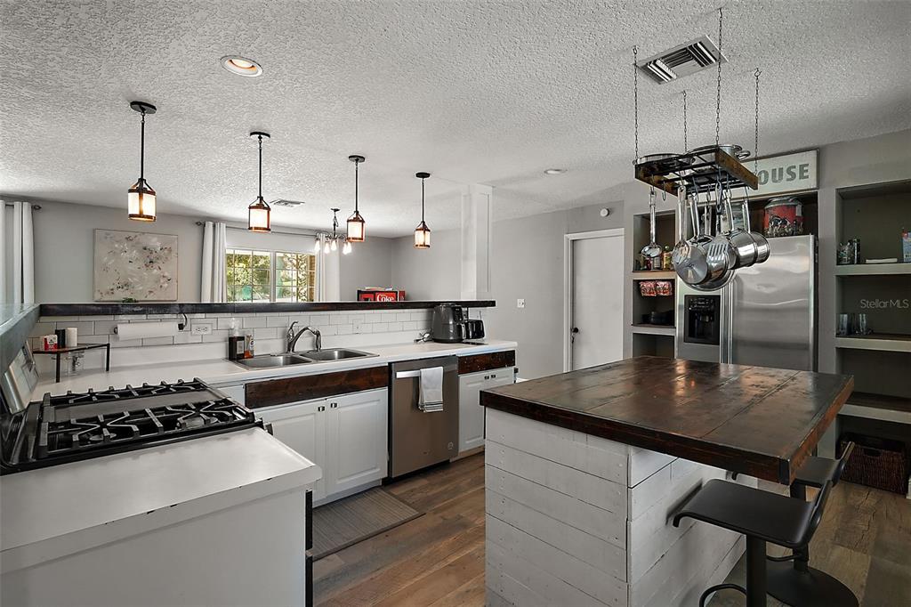 705 West Summit Court Mount Dora, FL 32757 - Photo 10 of 37 a kitchen with a stove a sink and chairs