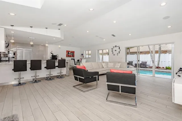 a living room with furniture window and wooden floor