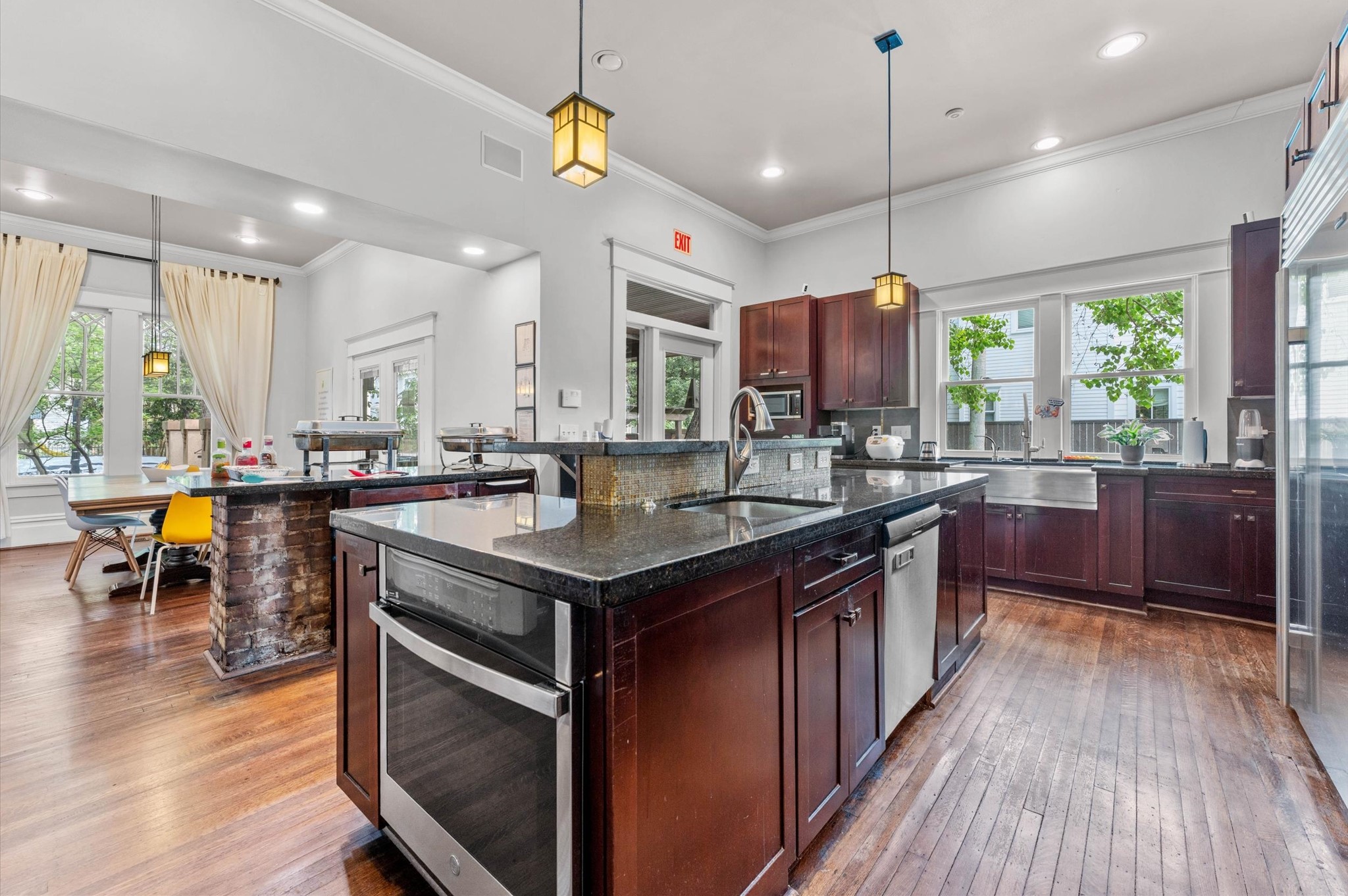 945 Harvard Street Houston, TX 77008 - Photo 15 of 47 a kitchen with stainless steel appliances granite countertop a stove a sink a refrigerator and a dining table with wooden floor