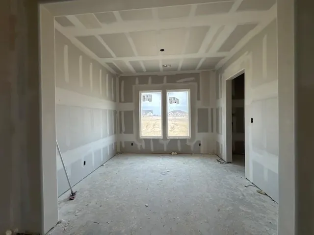 a view of an empty room with a window