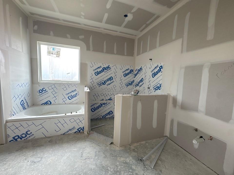 192 Brandywine Trail Rhome, TX 76078 - Photo 8 of 11 a bathroom with a bathtub and a shower