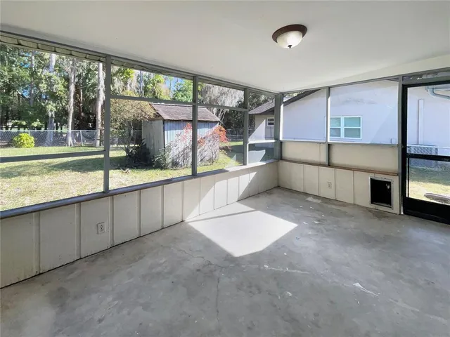 a large white kitchen with a large window and kitchen island