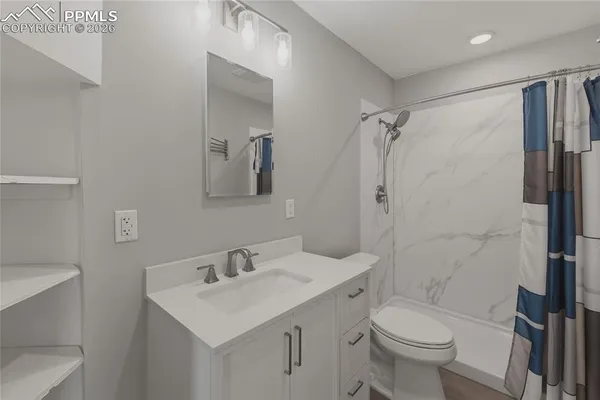 a bathroom with a sink toilet and shower