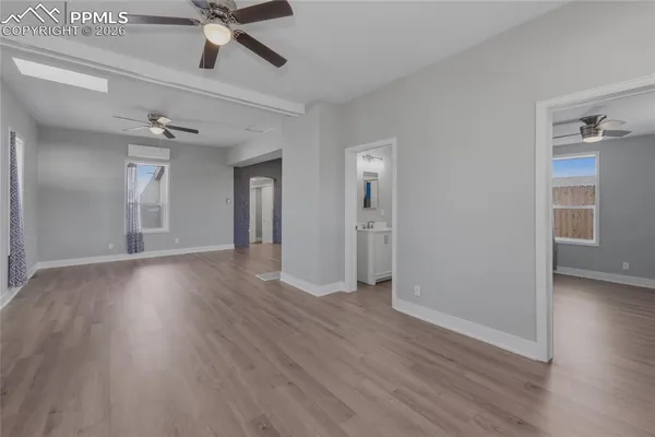 wooden floor in an empty room with a window