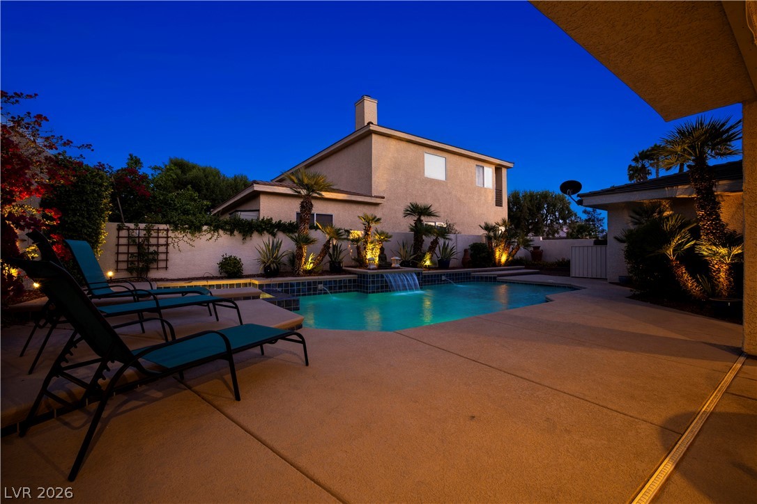 1135 Calico Ridge Drive Henderson, NV 89011 - Photo 71 of 86 An inviting pool, complete with a cascading waterfall, creates a backyard oasis perfect for evening relaxation.
