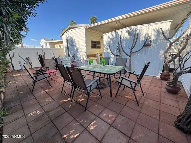 a view of a patio with table and chairs and potted plants