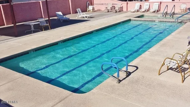 a view of swimming pool with seating area