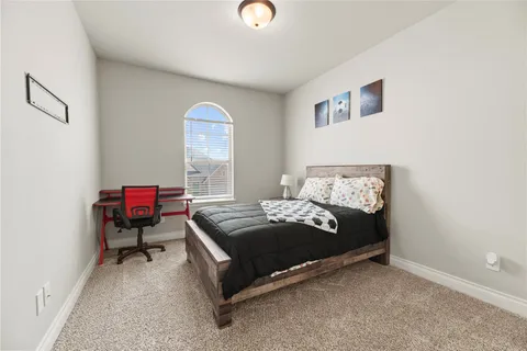 a bedroom with a bed and a chandelier