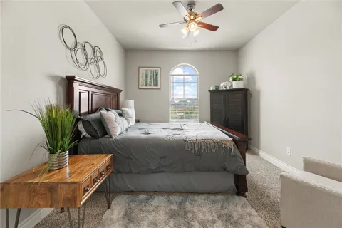 a bedroom with a large bed and a chandelier