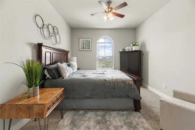 a bedroom with a large bed and a chandelier