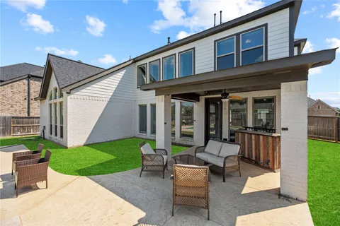 a view of a house with a yard and furniture
