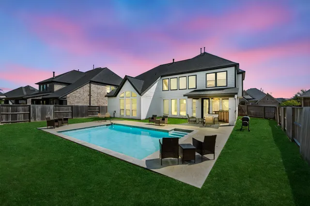 a view of an house with backyard space and balcony