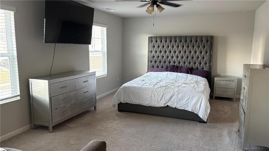 4475 Merrigold Way Fairburn, GA 30213 - Photo 11 of 22 a bedroom with a bed and a flat screen tv