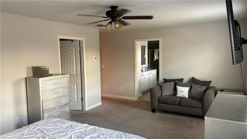 4475 Merrigold Way Fairburn, GA 30213 - Photo 13 of 22 a bedroom with a bed and a chandelier