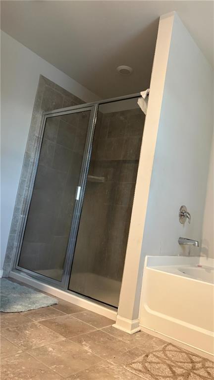 4475 Merrigold Way Fairburn, GA 30213 - Photo 14 of 22 a bathroom with a tub and a sink