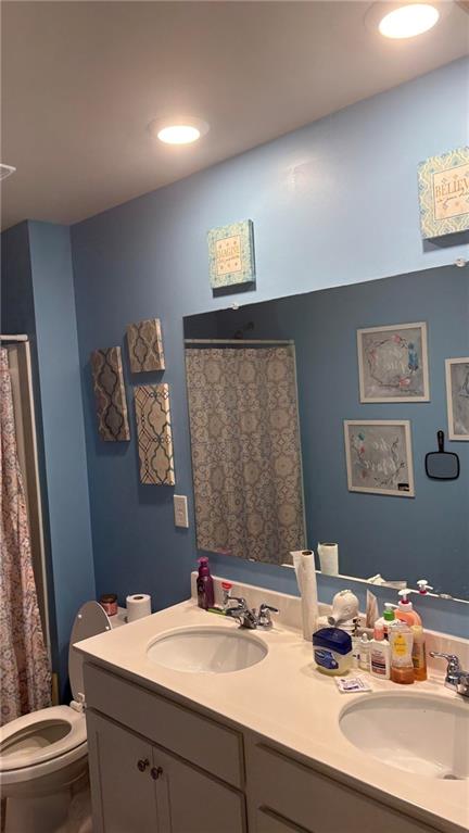 4475 Merrigold Way Fairburn, GA 30213 - Photo 18 of 22 a bathroom with a sink mirror vanity and toilet