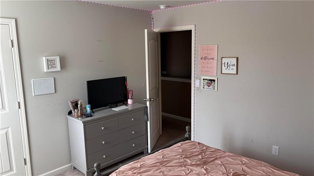 4475 Merrigold Way Fairburn, GA 30213 - Photo 19 of 22 a bedroom with a bed and a flat screen tv