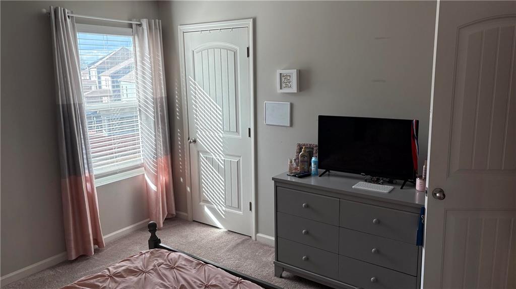 4475 Merrigold Way Fairburn, GA 30213 - Photo 20 of 22 a view of a livingroom with wooden floor and a flat screen tv