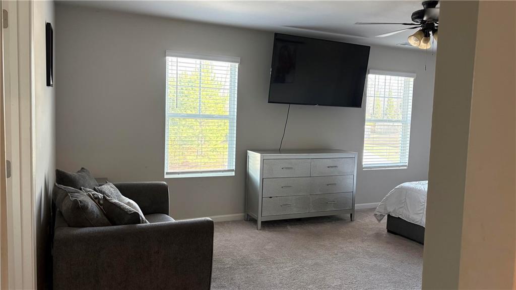 4475 Merrigold Way Fairburn, GA 30213 - Photo 21 of 22 a living room with furniture and a flat screen tv