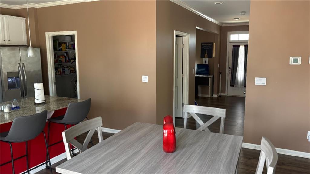4475 Merrigold Way Fairburn, GA 30213 - Photo 5 of 22 a view of a dining room with furniture and wooden floor