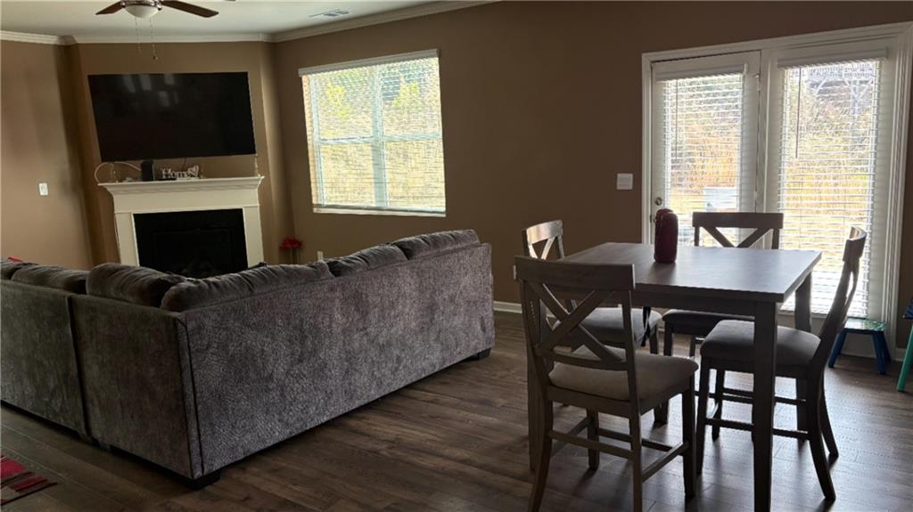 4475 Merrigold Way Fairburn, GA 30213 - Photo 6 of 22 a living room with furniture a flat screen tv and a fireplace