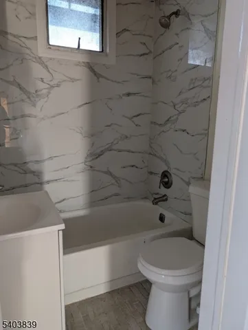 a bathroom with a toilet and shower