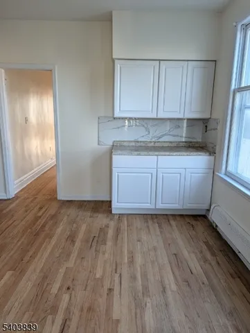 a kitchen with granite countertop wooden floors and granite counter tops