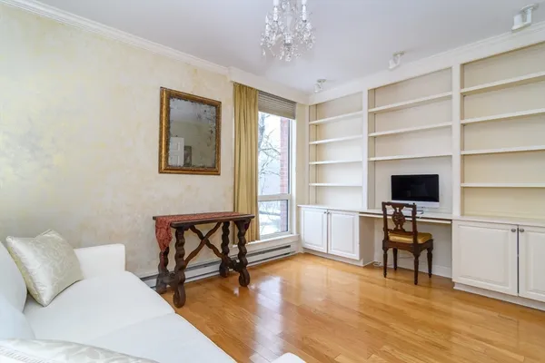 a living room with furniture and a flat screen tv with wooden floor