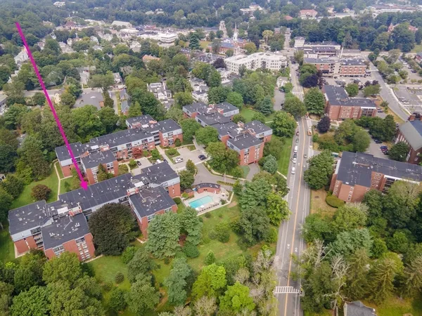 an aerial view of residential houses with outdoor space and street view