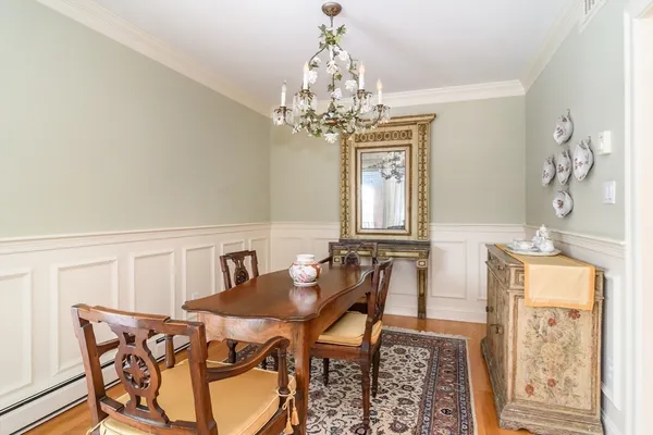 a view of a dining room with furniture and chandelier