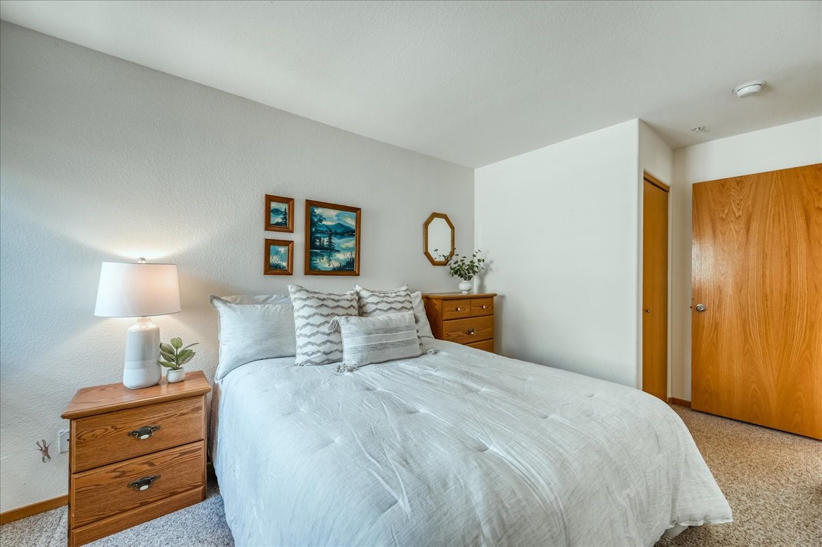 91399 Ryan Gulch Road, Unit B6 Silverthorne, CO 80498 - Photo 14 of 36 a bed room with a bed and a night stand