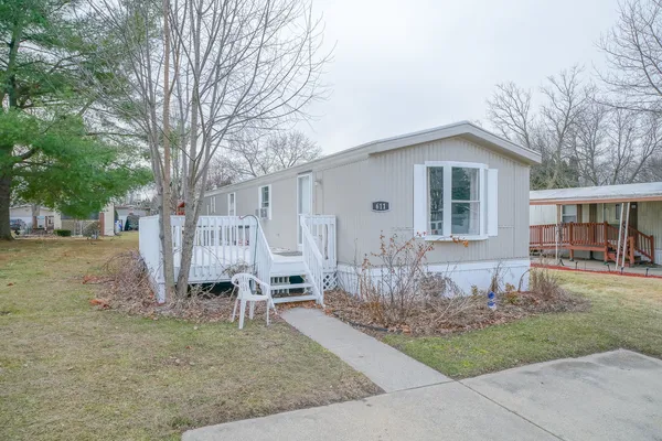 a backyard of a house with table and chairs