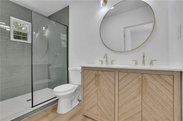 a bathroom with a sink a toilet and a mirror