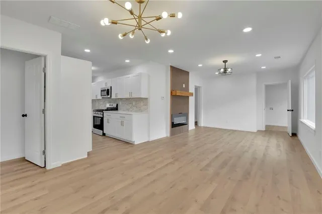 a view of a kitchen with a sink and a refrigerator