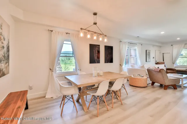 a view of a dining room with furniture window and wooden floor