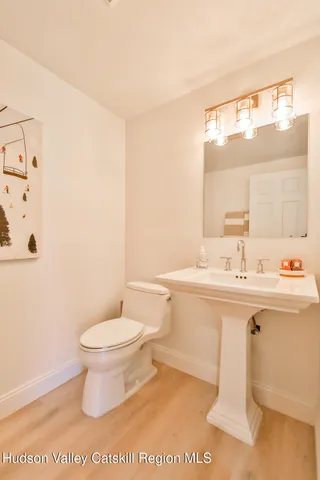 a bathroom with a sink toilet and mirror