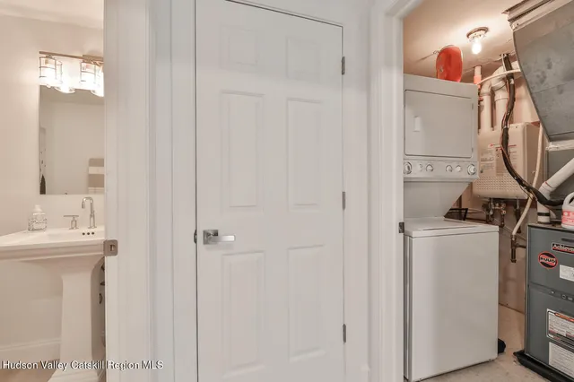 a bathroom with a sink and mirror with toilet