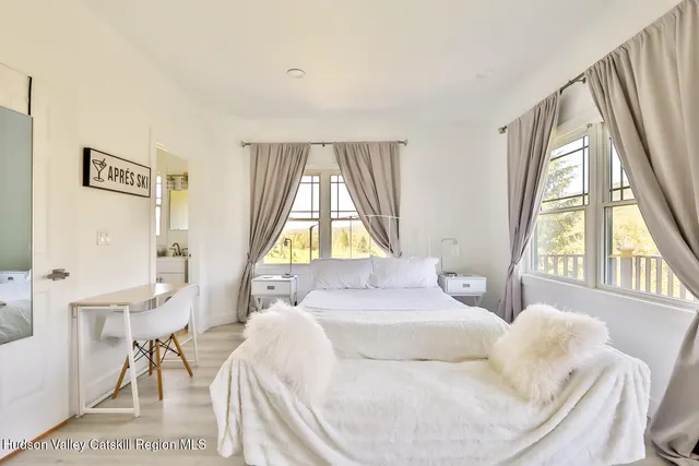 a bedroom with a bed and a large window