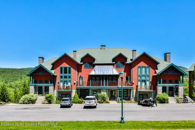a front view of residential houses with yard