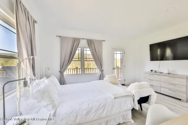 a bedroom with a bed and a flat screen tv