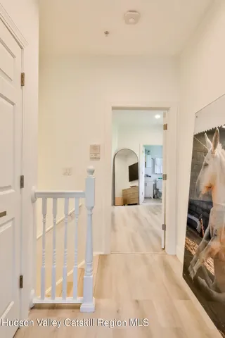a view of a bedroom with furniture and floor to ceiling window
