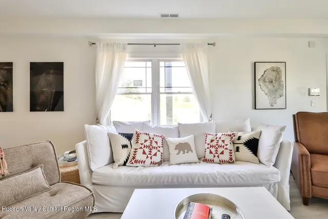 a living room with a couch and a window