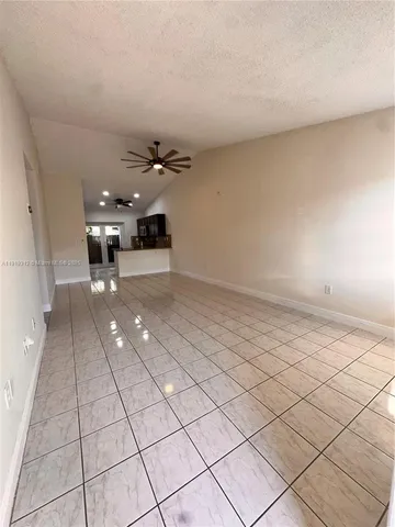 a view of an empty room and a window