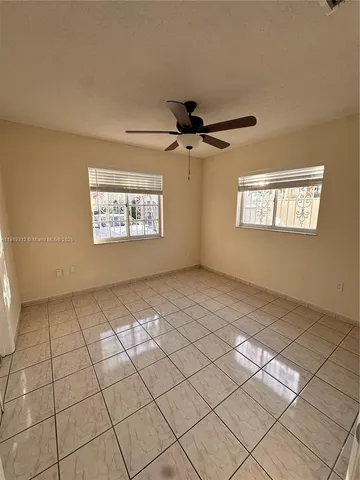 a view of an empty room and a window